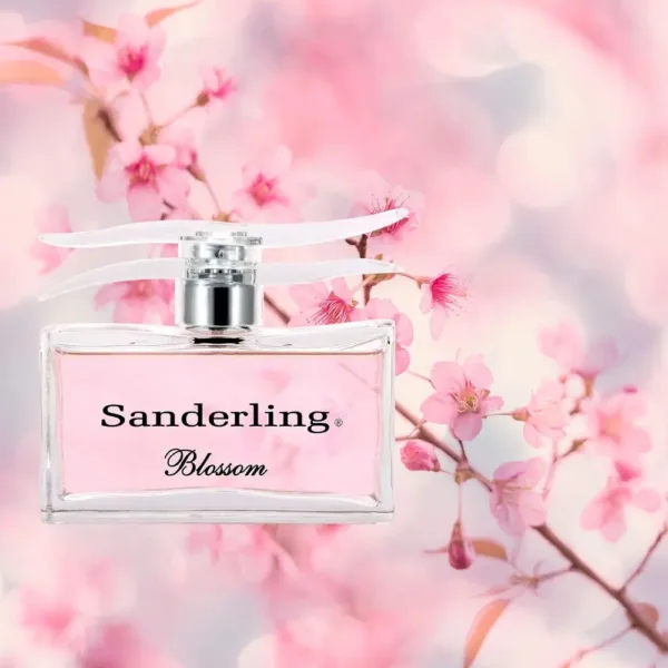 Flacon de parfum Sanderling Blossom devant des fleurs roses floues.