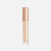 Tube de correcteur TopFace Instyle Lasting Finish avec bouchon doré et corps transparent montrant le produit beige.
