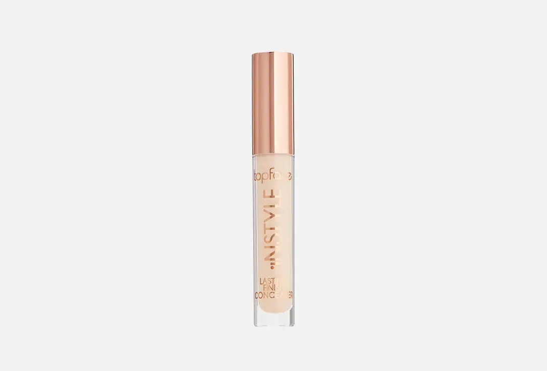 Tube de correcteur TopFace Instyle Lasting Finish avec bouchon doré et corps transparent montrant le produit beige.