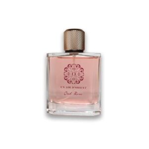 Flacon de parfum rose Ex Air D’orient avec capuchon métallique et emblème complexe.